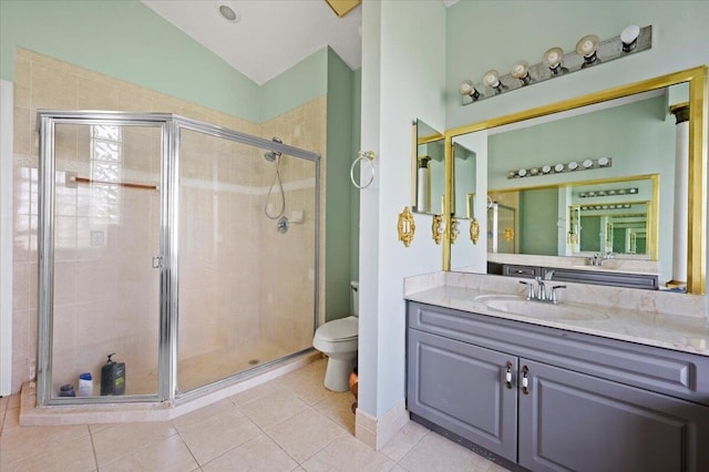 bathroom with an enclosed shower, vanity, vaulted ceiling, tile patterned flooring, and toilet