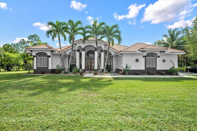 mediterranean / spanish home with a front yard