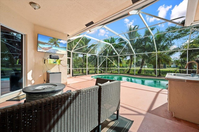 view of swimming pool featuring a lanai and a patio