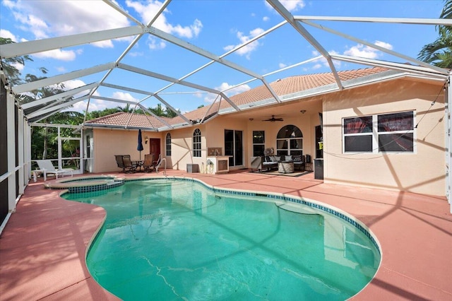 view of pool with an in ground hot tub, glass enclosure, ceiling fan, and a patio area