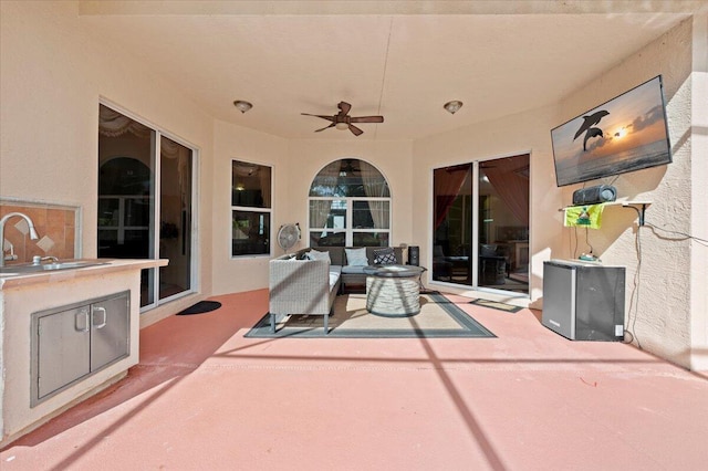 view of patio / terrace with ceiling fan, area for grilling, an outdoor hangout area, and sink