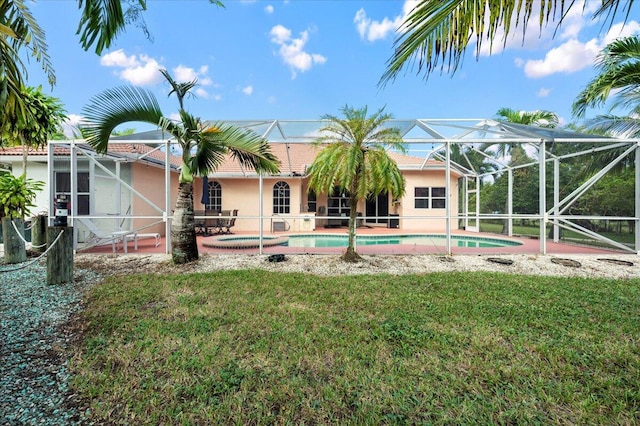 view of swimming pool featuring a lanai and a lawn