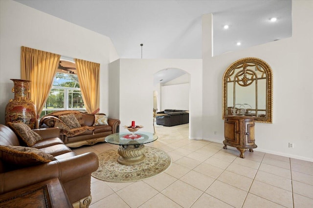 living room featuring a towering ceiling and light tile patterned flooring