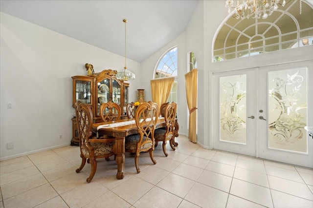 dining room featuring french doors, light tile patterned floors, high vaulted ceiling, and a notable chandelier