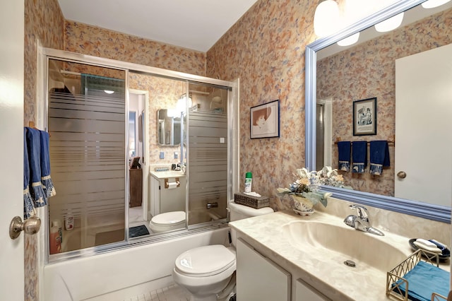 full bathroom featuring enclosed tub / shower combo, tile patterned floors, toilet, and vanity