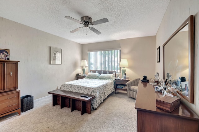 bedroom with a textured ceiling, light carpet, and ceiling fan