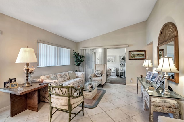 living room with plenty of natural light, light tile patterned floors, and vaulted ceiling