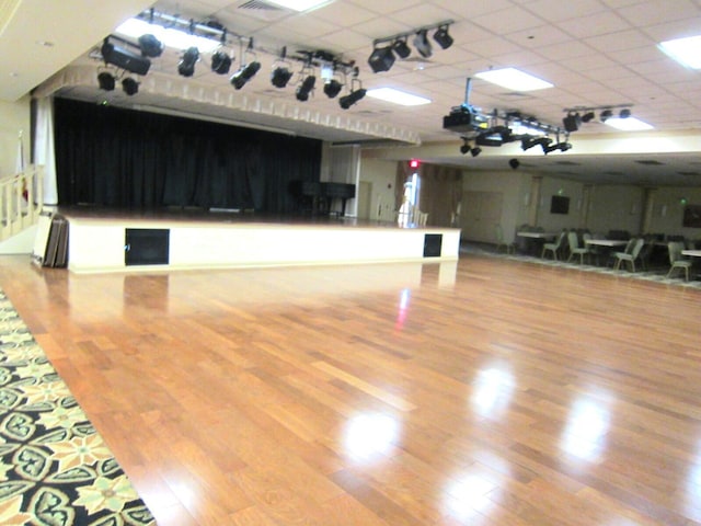 miscellaneous room featuring a drop ceiling and wood-type flooring