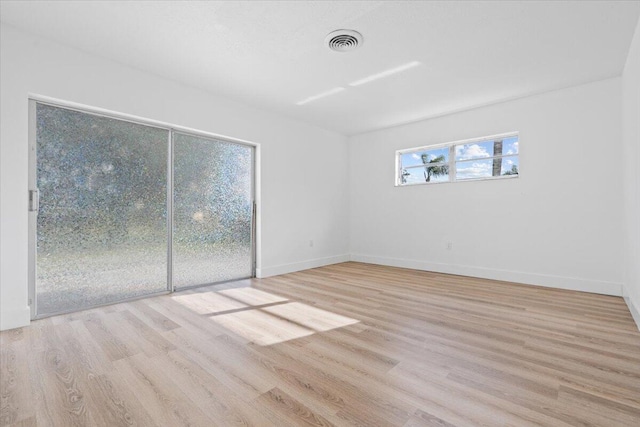 unfurnished room featuring light hardwood / wood-style flooring