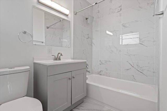 full bathroom with toilet, vanity, and tiled shower / bath