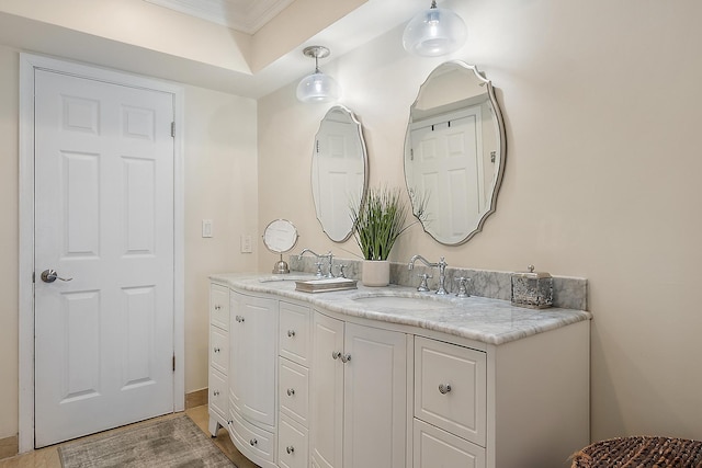 bathroom with vanity, crown molding, and a tray ceiling