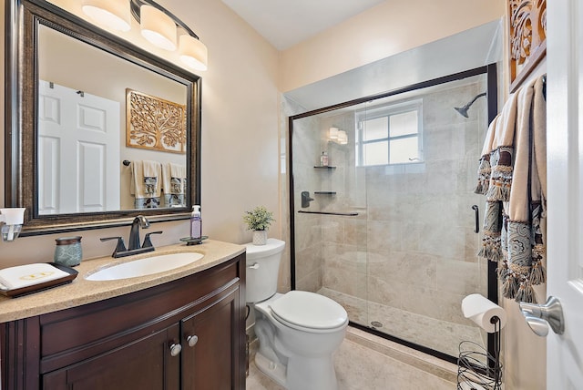 bathroom with walk in shower, vanity, and toilet