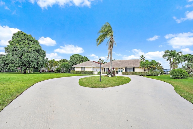 ranch-style home featuring a front yard