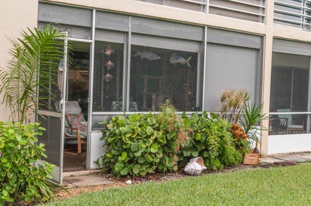 view of property exterior with a sunroom