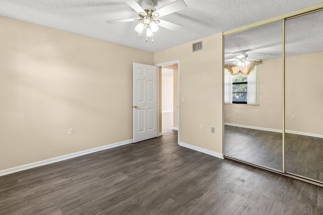 unfurnished bedroom featuring a closet, a textured ceiling, ceiling fan, and dark hardwood / wood-style floors