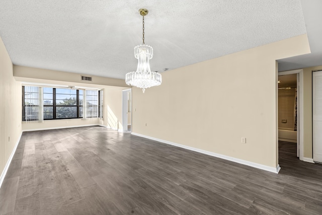 interior space featuring dark hardwood / wood-style floors, a textured ceiling, and an inviting chandelier