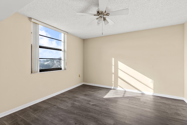 empty room featuring dark hardwood / wood-style flooring, a textured ceiling, and ceiling fan