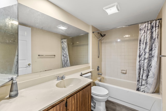 full bathroom with hardwood / wood-style floors, vanity, shower / bath combo with shower curtain, and toilet