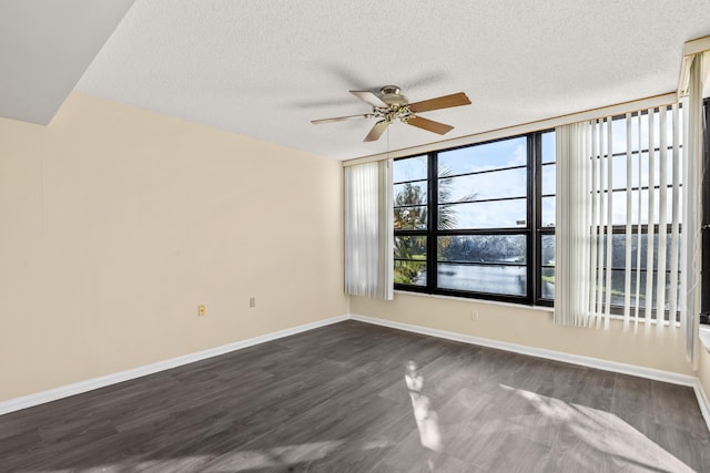 unfurnished room with dark hardwood / wood-style flooring, a textured ceiling, and ceiling fan