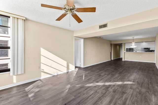 unfurnished living room featuring dark hardwood / wood-style flooring, a textured ceiling, and ceiling fan