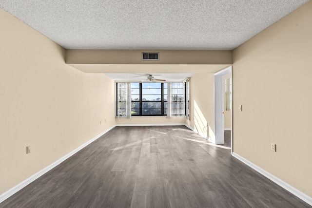 spare room featuring a textured ceiling, dark hardwood / wood-style floors, and ceiling fan