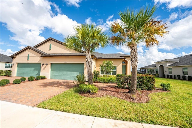 view of front facade with a front yard and a garage