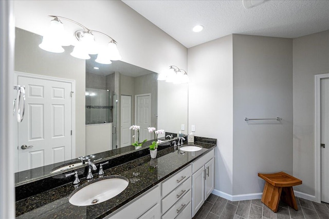 bathroom featuring walk in shower, vanity, a textured ceiling, and hardwood / wood-style flooring