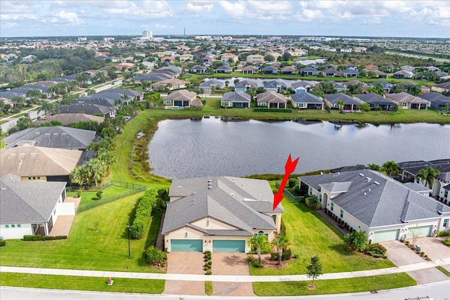 birds eye view of property with a water view