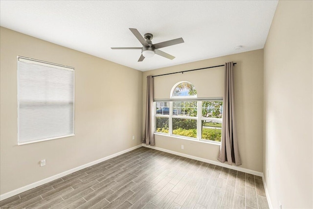 empty room featuring hardwood / wood-style flooring and ceiling fan