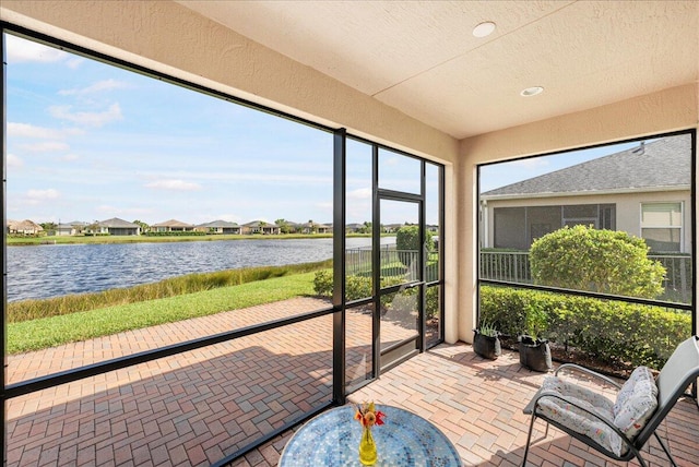 sunroom / solarium with a water view