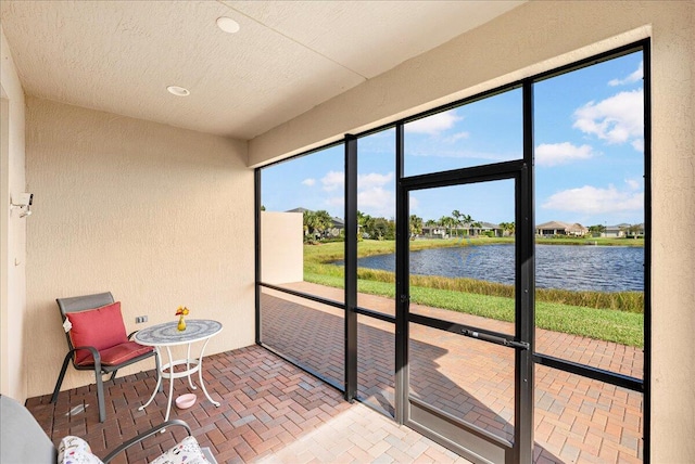 sunroom / solarium with a water view