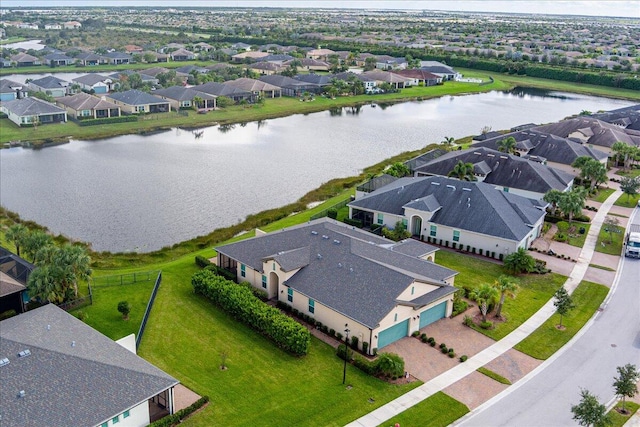 birds eye view of property with a water view