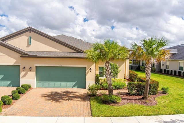 view of front of home featuring a garage and a front lawn