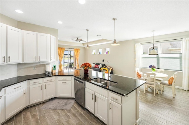 kitchen with white cabinetry, hanging light fixtures, and sink