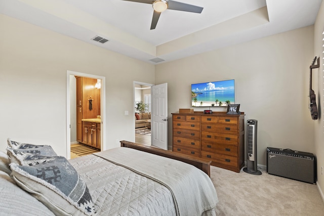 11507 SW Lake Park Dr, Port Saint Lucie, FL 34987 - bedroom featuring light colored carpet, a ceiling fan, connected bathroom, a raised ceiling, and baseboards