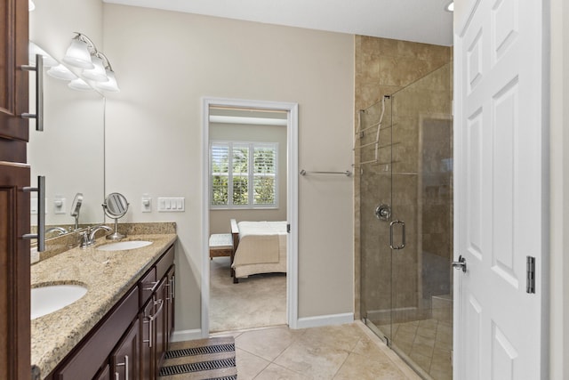 11507 SW Lake Park Dr, Port Saint Lucie, FL 34987 - bathroom featuring double vanity, a stall shower, connected bathroom, tile patterned floors, and baseboards
