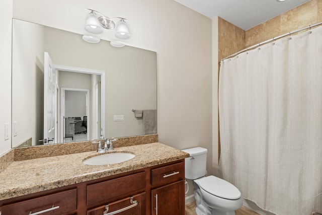 bathroom featuring toilet and vanity