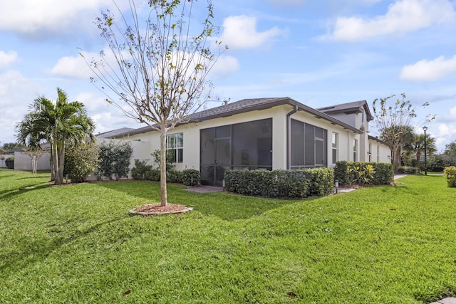 11507 SW Lake Park Dr, Port Saint Lucie, FL 34987 - back of house with stucco siding, a lawn, and a sunroom