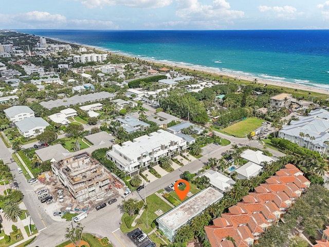 bird's eye view featuring a water view and a beach view