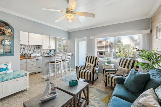 living room with ceiling fan and ornamental molding