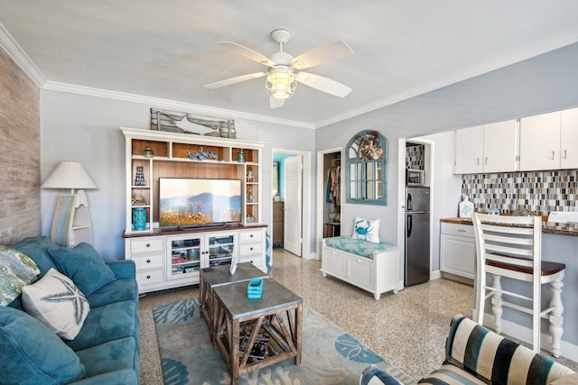 living room with ceiling fan, crown molding, and wood walls