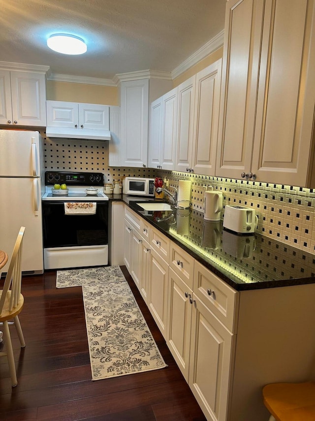 kitchen with decorative backsplash, dark hardwood / wood-style flooring, ornamental molding, white appliances, and white cabinetry