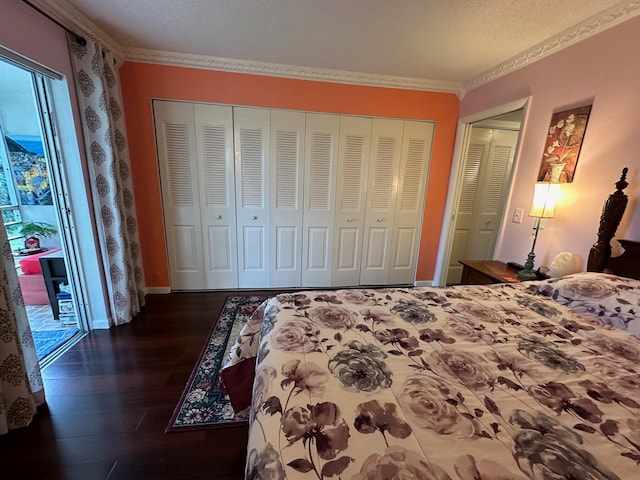 bedroom with dark hardwood / wood-style flooring, ornamental molding, a textured ceiling, and multiple windows