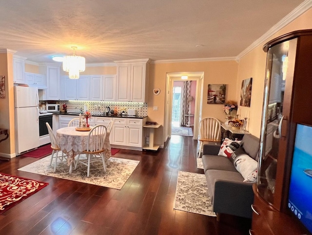 kitchen featuring white cabinets, dark hardwood / wood-style flooring, white appliances, and crown molding