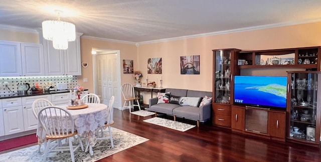 interior space with a notable chandelier, dark hardwood / wood-style flooring, and ornamental molding