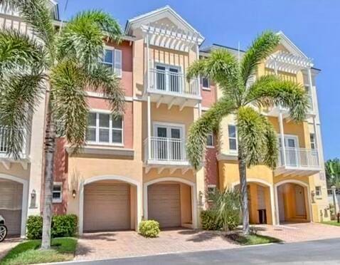 view of property with a balcony and a garage