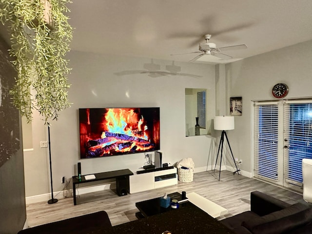 home theater with hardwood / wood-style flooring and ceiling fan