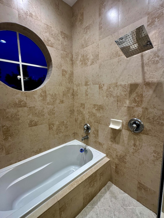 bathroom featuring tile patterned floors and tiled shower / bath