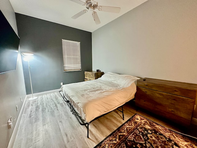 bedroom featuring wood-type flooring, ceiling fan, and lofted ceiling