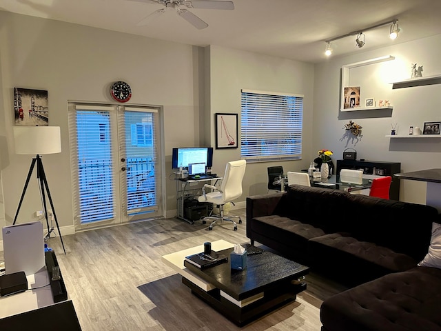 living room with light hardwood / wood-style flooring and ceiling fan